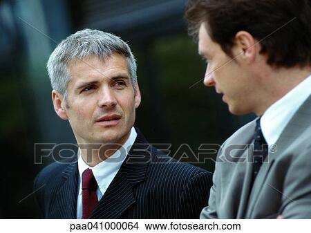 Two businessmen side by side, close-up View Large Photo Image Picture - Two businessmen side by side, close-up. Fotosearch