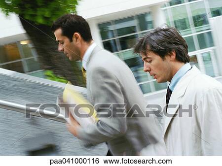 Two businessmen walking up stairs, upper section, blurred View Large Photo Image Stock Photograph - Two businessmen walking up stairs, upper section, blurred. Fotosearch