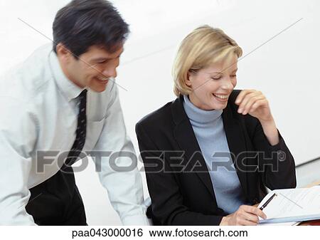 Businessman and businesswoman laughing View Large Photo Image Stock Photograph - Businessman and businesswoman laughing. Fotosearch