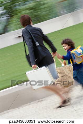 Businesswoman and child outside, walking and holding hands, blurred View Large Photo Image Stock Image - Businesswoman and child outside, walking and holding hands, blurred. Fotosearch