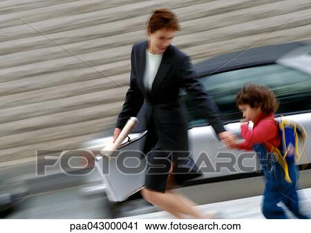 Businesswoman and child walking and holding hands, blurred motion View Large Photo Image Stock Image - Businesswoman and child walking and holding hands, blurred motion. Fotosearch