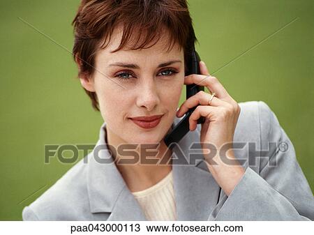 Businesswoman holding cell phone, looking at camera, portrait View Large Photo Image Stock Image - Businesswoman holding cell phone, looking at camera, portrait. Fotosearch