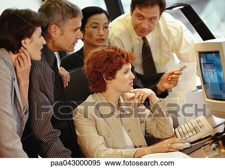 Stock Photography - Five business people grouped around computer screen. Fotosearch