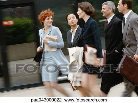 Group of business people walking side by side, blurred View Large Photo Image Stock Image - Group of business people walking side by side, blurred. Fotosearch