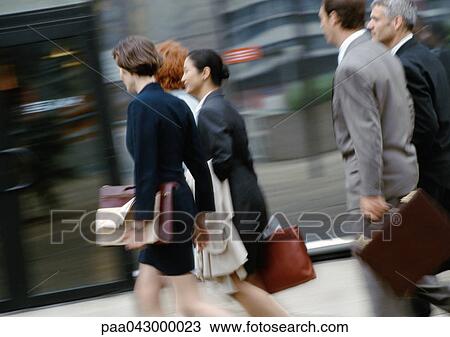 Group of business people walking, side view, blurred View Large Photo Image Stock Image - Group of business people walking, side view, blurred. Fotosearch