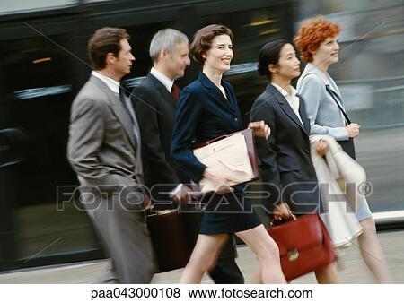 Stock Photo - Group of business people walking, blurred. Fotosearch