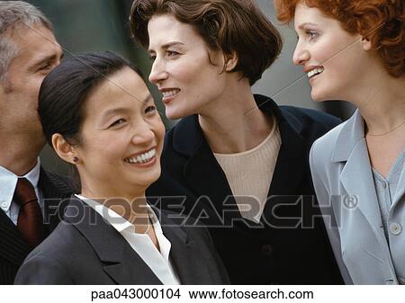 Group of four business people, smiling, close-up View Large Photo Image Picture - Group of four business people, smiling, close-up. Fotosearch