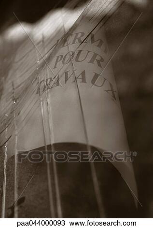 Stock Image - Closed for repairs text in French on paper behind glass, close-up. Fotosearch