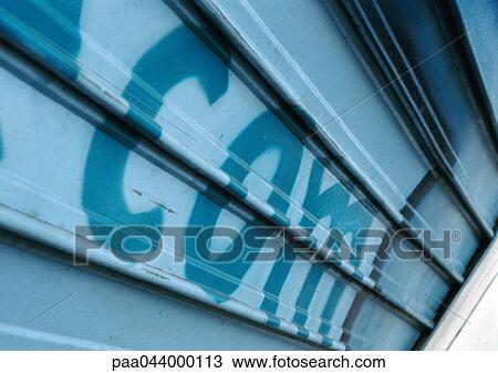 Com text painted on roller shutter, close-up View Large Photo Image Stock Image - Com text painted on roller shutter, close-up. Fotosearch