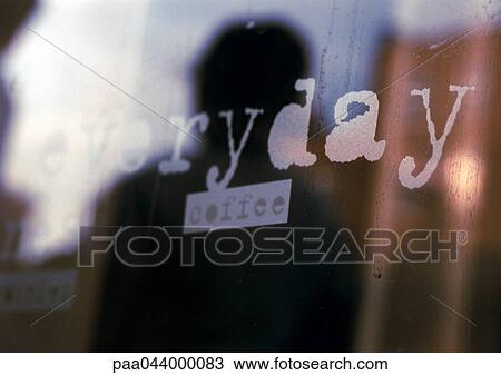 Stock Image - Everyday, coffee text on shop window, close-up. Fotosearch