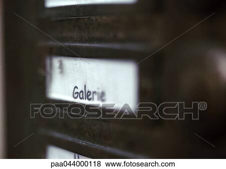 Stock Photo - Gallery text in French on entry phone, close-up. Fotosearch
