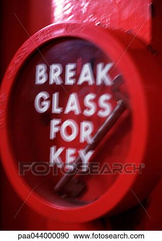Stock Image - Key behind glass with "break glass for key" text. Fotosearch