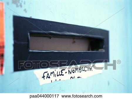 Stock Photo - Large family written in French on sticker under mail slot. Fotosearch