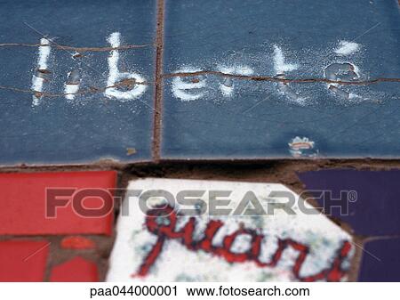 Stock Image - Liberty, in french written on tiles, close-up. Fotosearch