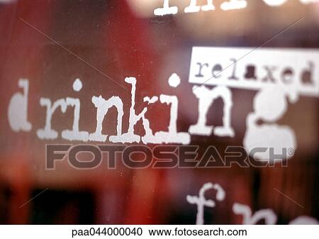 Stock Image - Relaxed, drinking text on window, close-up. Fotosearch