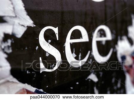 Stock Image - See text printed on torn poster, close-up. Fotosearch