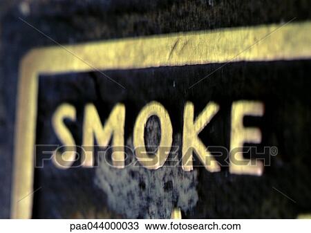 Stock Image - Smoke text on sign, close-up. Fotosearch