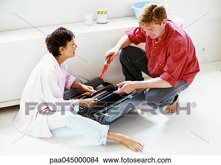 Man and woman with toolbox between them on floor, full length View Large Photo Image Picture - Man and woman with toolbox between them on floor, full length. Fotosearch