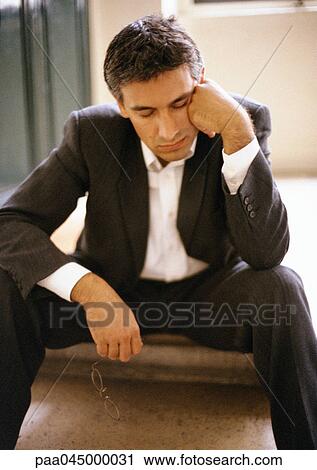 Man sitting on steps, leaning head against hand, eyes closed, mid-length, close-up View Large Photo Image Stock Image - Man sitting on steps, leaning head against hand, eyes closed, mid-length, close-up. Fotosearch