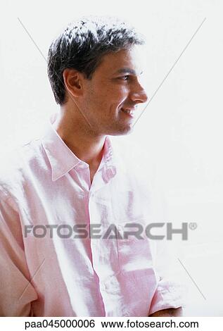 Man with head turned to side, head and shoulders, backlit, close-up View Large Photo Image Stock Photograph - Man with head turned to side, head and shoulders, backlit, close-up. Fotosearch