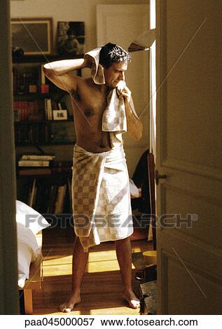Man with towel wrapped around waist, drying hair with towel, full length View Large Photo Image Stock Photo - Man with towel wrapped around waist, drying hair with towel, full length. Fotosearch