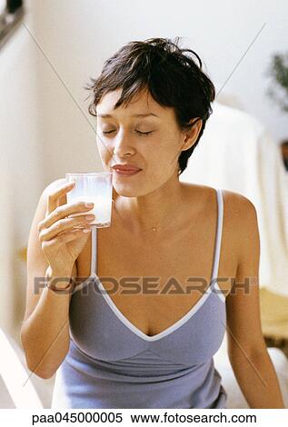 Woman holding glass, eyes closed, waist up, close-up View Large Photo Image Stock Photography - Woman holding glass, eyes closed, waist up, close-up. Fotosearch