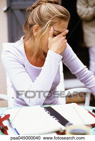 Woman sitting, hand on face, waist up, close-up View Large Photo Image Stock Image - Woman sitting, hand on face, waist up, close-up. Fotosearch