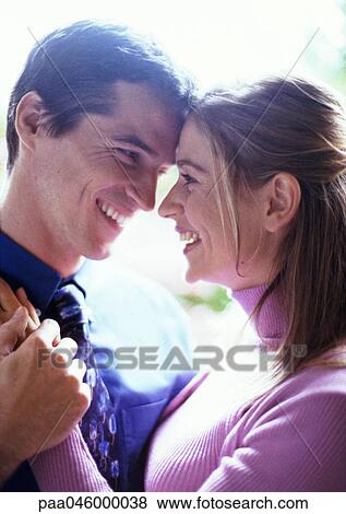 Couple embracing, side view, close-up View Large Photo Image Stock Photo - Couple embracing, side view, close-up. Fotosearch