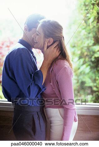 Couple embracing, side view View Large Photo Image Stock Image - Couple embracing, side view. Fotosearch