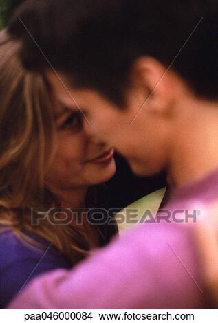 Picture - Couple hugging, close-up, blurred. Fotosearch