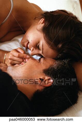 Couple lying in bed, face to face, close-up of heads View Large Photo Image Stock Image - Couple lying in bed, face to face, close-up of heads. Fotosearch