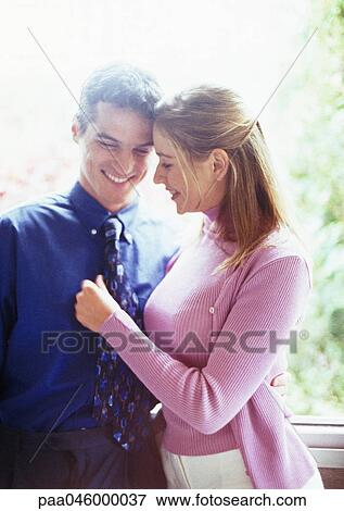 Couple standing close together, smiling, waist up View Large Photo Image Stock Photo - Couple standing close together, smiling, waist up. Fotosearch