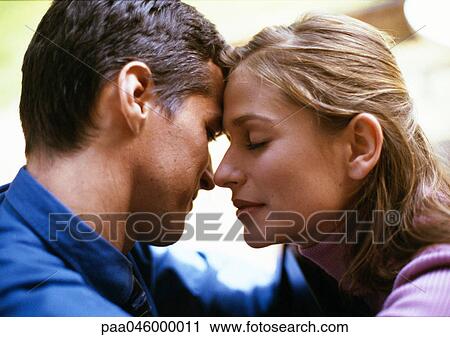 Man and woman, foreheads touching, woman's eyes closed, side view, close-up View Large Photo Image Stock Image - Man and woman, foreheads touching, woman's eyes closed, side view, close-up. Fotosearch