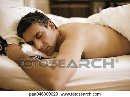 Man lying on stomach in bed, elbow out, eyes closed, waist up View Large Photo Image Stock Photo - Man lying on stomach in bed, elbow out, eyes closed, waist up. Fotosearch