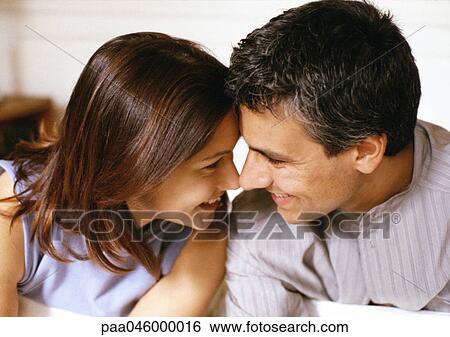 Woman and man smiling, foreheads and noses touching, side view, close-up View Large Photo Image Stock Photograph - Woman and man smiling, foreheads and noses touching, side view, close-up. Fotosearch
