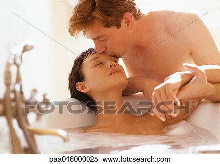Woman in bubble bath, head back, eyes closed, man kissing her forehead View Large Photo Image Stock Photography - Woman in bubble bath, head back, eyes closed, man kissing her forehead. Fotosearch