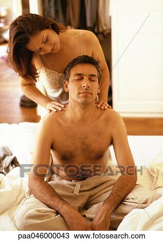 Woman massaging bare-chested man's shoulders View Large Photo Image Stock Image - Woman massaging bare-chested man's shoulders. Fotosearch