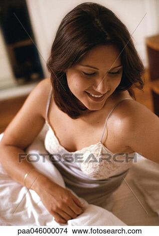 Woman sitting in bed View Large Photo Image Picture - Woman sitting in bed. Fotosearch