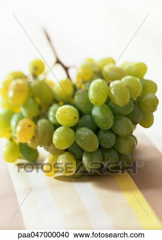 Stock Image - Bunch of green grapes, close-up. Fotosearch
