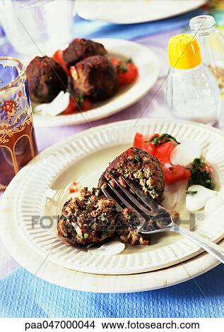 Picture - Meatballs with herbs on plates, close-up. Fotosearch