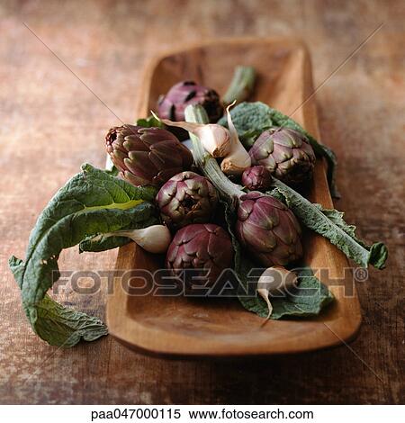Purple artichokes with leaves and garlic cloves in wooden container, close-up View Large Photo Image Stock Photography - Purple artichokes with leaves and garlic cloves in wooden container, close-up. Fotosearch