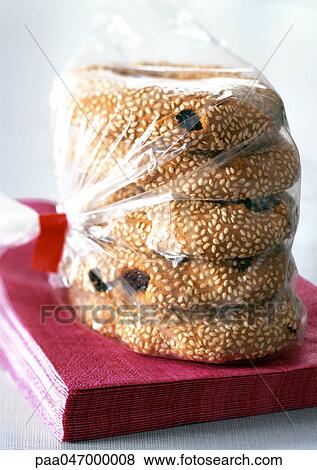 Stock Photo - Raisin sesame cookies in plastic bag, close-up. Fotosearch