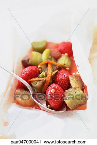 Stock Image - Rhubarb and strawberries in cooking paper. Fotosearch