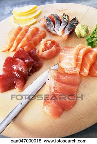 Sashimi with wasabi and lemon slices on wooden board View Large Photo Image Stock Photo - Sashimi with wasabi and lemon slices on wooden board. Fotosearch