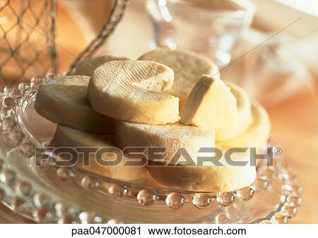 Stock Image - Stack of goat cheese on plate, close-up. Fotosearch