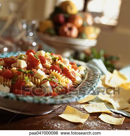 Tortellini with mozzarella, tomato, and basil View Large Photo Image Stock Photo - Tortellini with mozzarella, tomato, and basil. Fotosearch