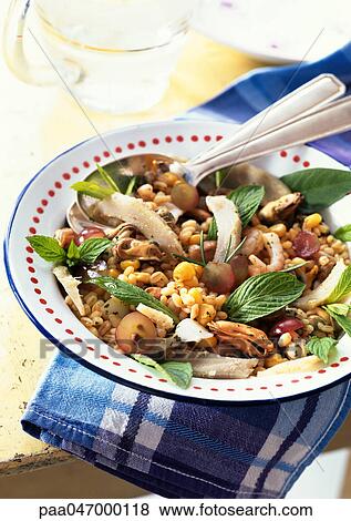 Stock Photo - Wheat salad with mussels and herbs, close-up. Fotosearch