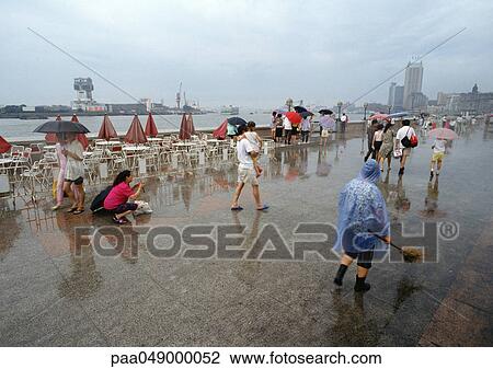 China, Shanghai, The Bund, people walking in rain View Large Photo Image Stock Image - China, Shanghai, The Bund, people walking in rain. Fotosearch