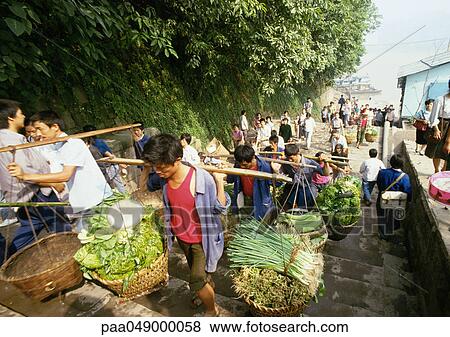 Stock Photo - China, Sichuan, Chongqing, people walking upstairs carrying yokes . Fotosearch