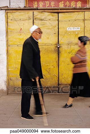 China, Xingjiang Province, Turpan, man in street walking with cane, blurred motion View Large Photo Image Picture - China, Xingjiang Province, Turpan, man in street walking with cane, blurred motion. Fotosearch